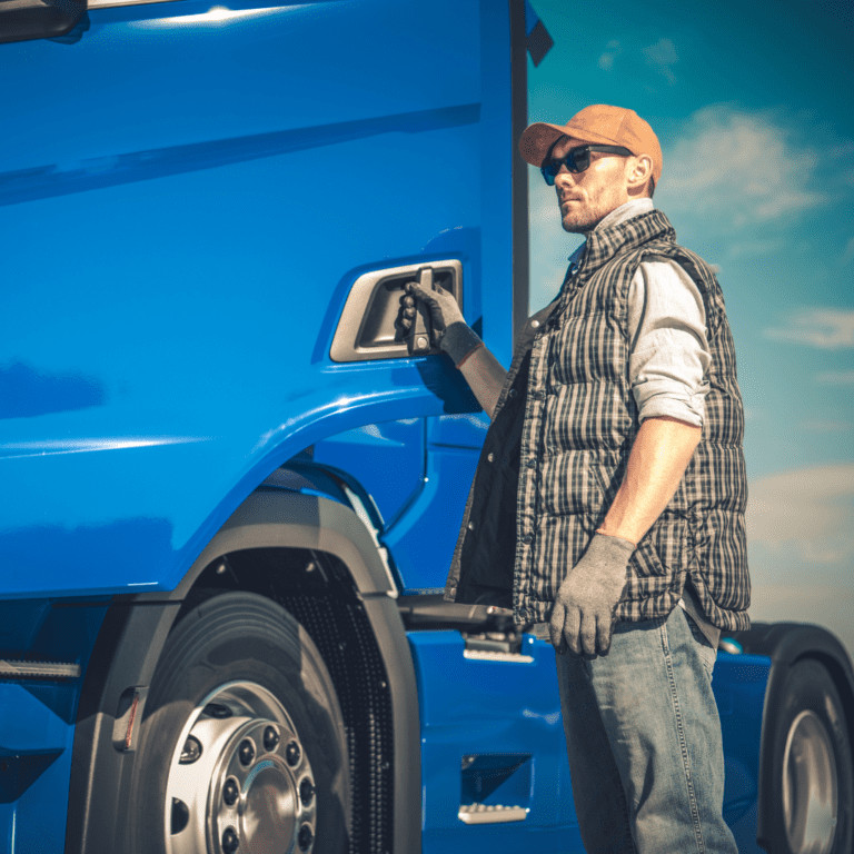 En la imagen se observa un camionero abriendo la puerta de un camión