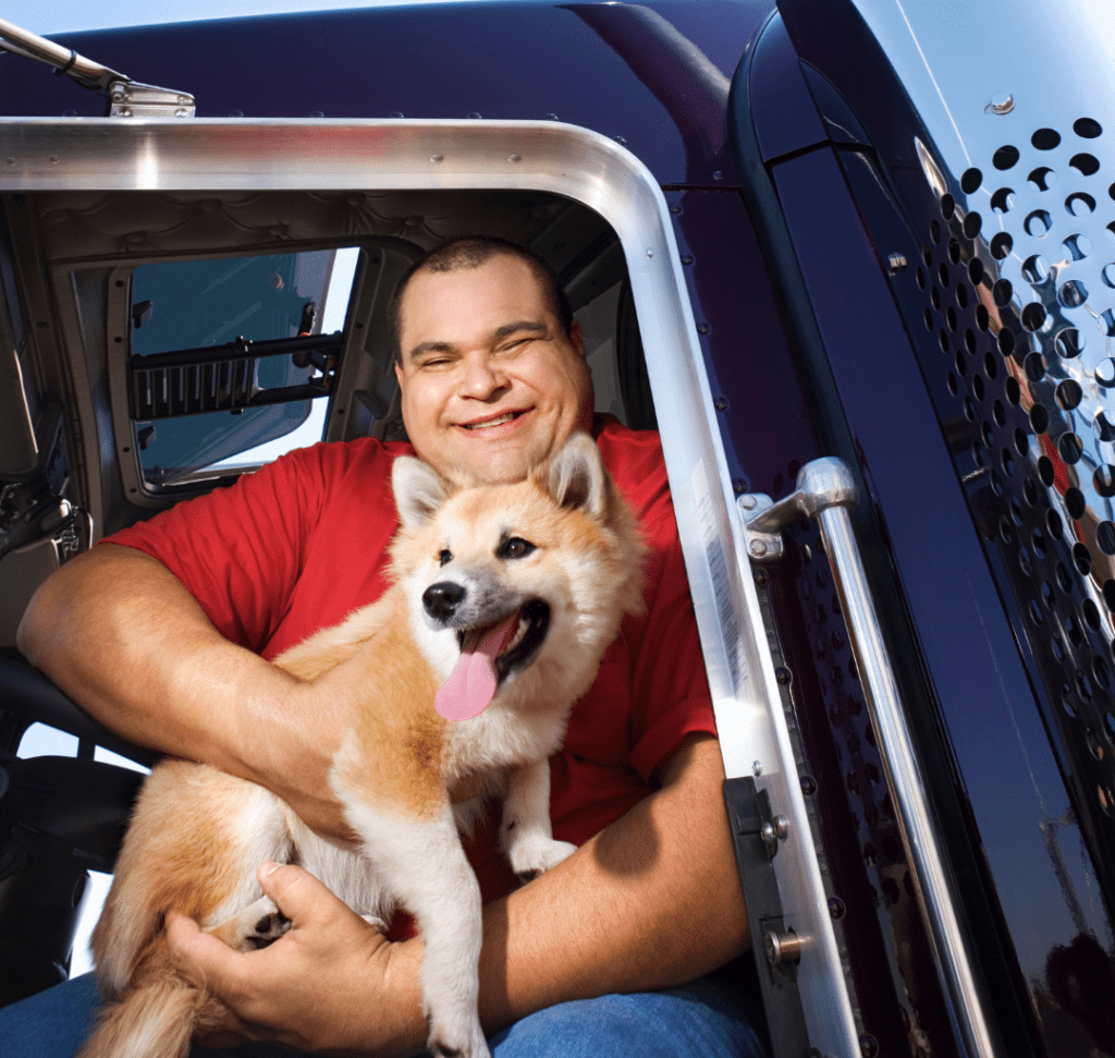En la imagen se muestra un camionero con un perro