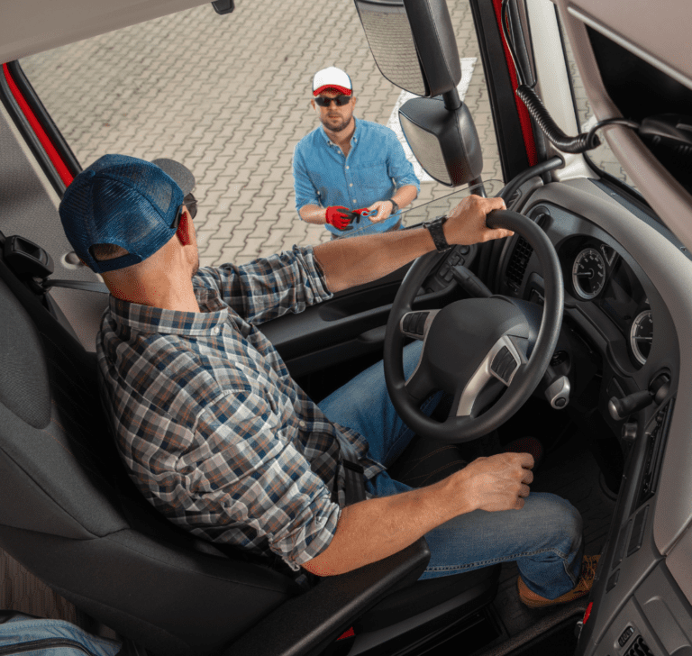 En la imagen se muestra un hombre dentro de un camión y otro fuera