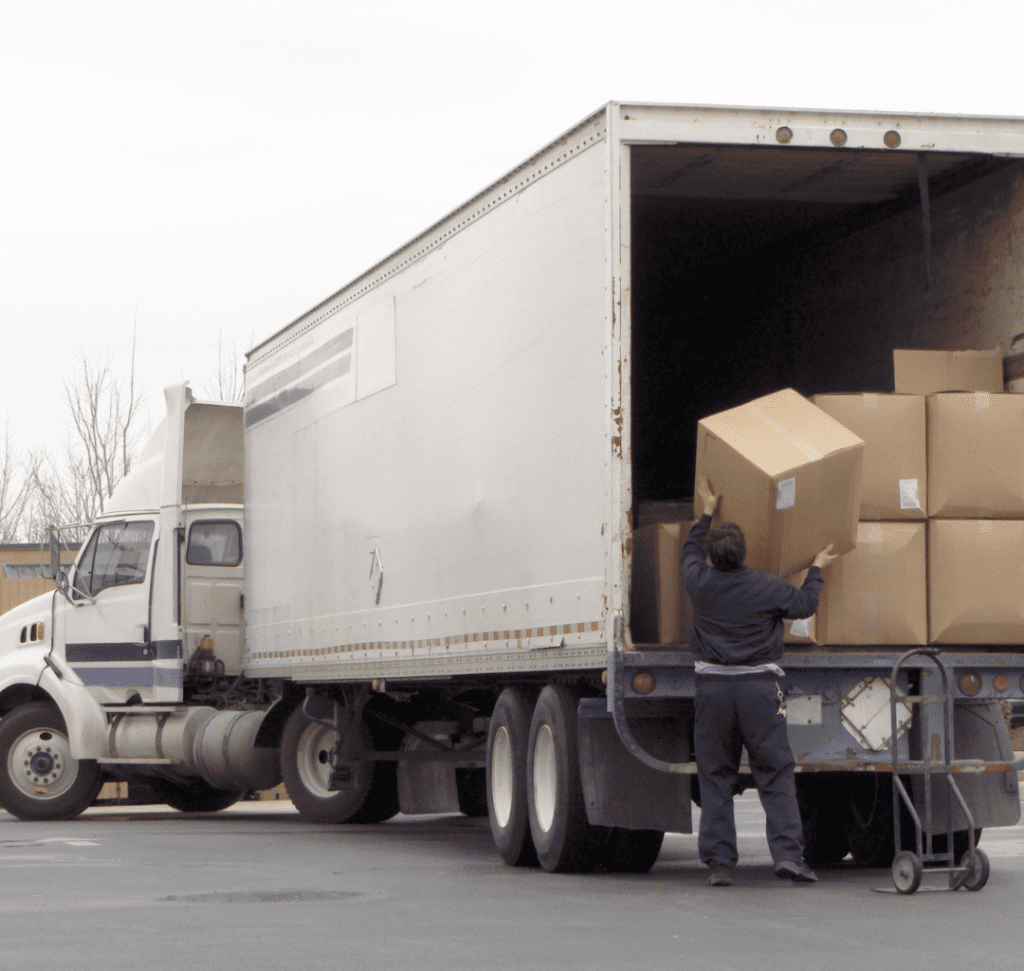 En la imagen se muestra un hombre cargando mercancía a un camión